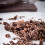 Glamorous cake adorned with sparkling gems and surrounded by KitKat bars for a luxurious touch