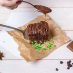 Pumpkin cake decorated with cream cheese frosting and autumn-themed sugar sprinkles