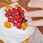 A close-up of a decadent Ferrero cake with rich chocolate frosting and Ferrero Rocher decorations