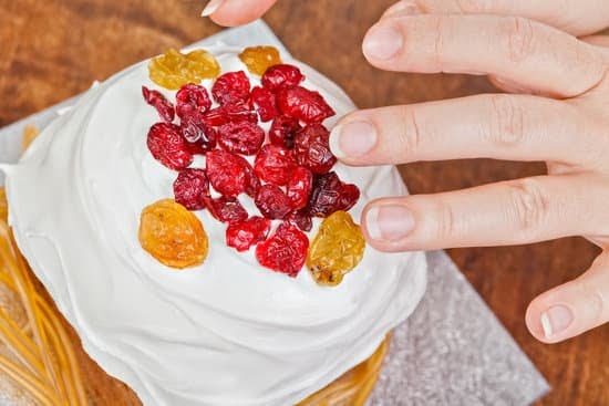 Ferrero Cake Decoration 1 A close-up of a decadent Ferrero cake with rich chocolate frosting and Ferrero Rocher decorations