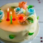 Decorating Cake With Fake Flowers Cake being artistically decorated with vibrant fake flowers for a stunning visual effect