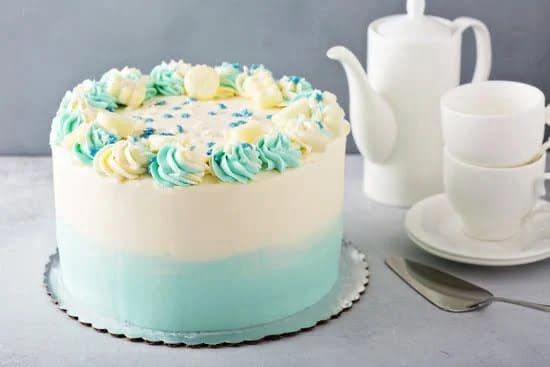 Decorating a Cake With Flowers 1 Beautifully decorated cake adorned with delicate flowers, showcasing expert cake decorating skills