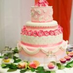 Decorated Wedding Cake Cookies Sugar cookies shaped like wedding cakes, beautifully decorated with intricate designs and icing details
