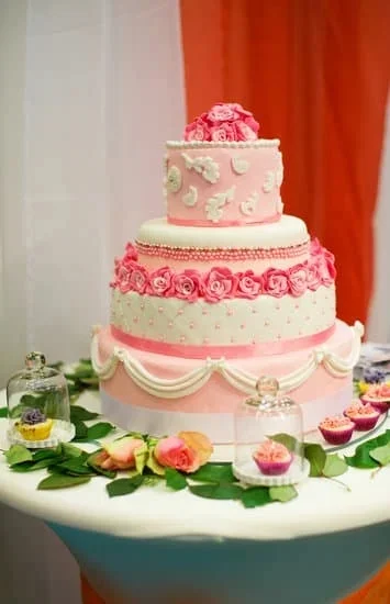 Sugar cookies shaped like wedding cakes, beautifully decorated with intricate designs and icing details