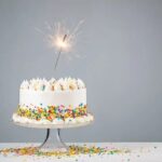 A close-up of smooth and glossy cake decorating paste being spread onto a delicious cake