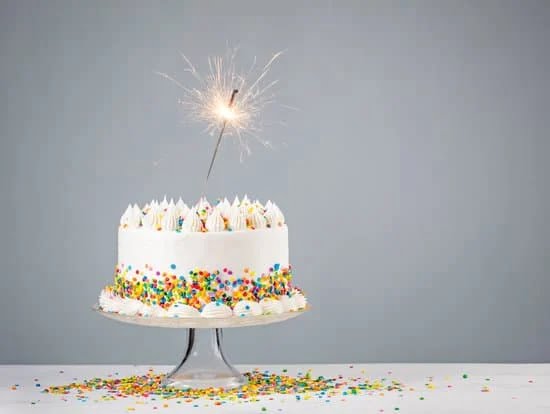 A close-up of smooth and glossy cake decorating paste being spread onto a delicious cake