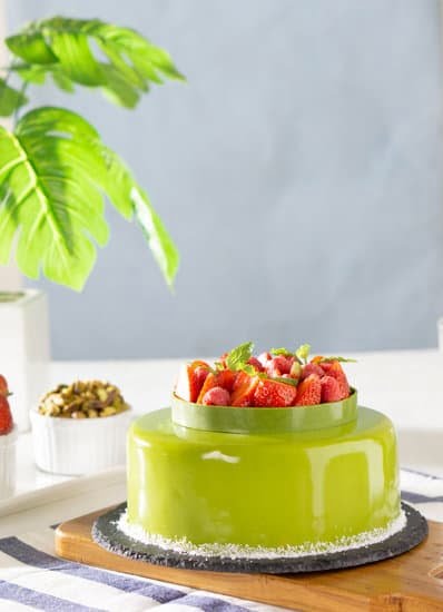 Merry Christmas Cake Decoration 1 Festive holiday-themed cake with 'Merry Christmas' written in elegant icing alongside decorative ornaments