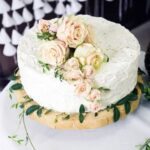 Elegant three-tier Christmas cake stand adorned with festive decorations for a stunning holiday centerpiece