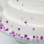 Cake Ball Decorating Tips Spoon dipping chocolate over cake balls for a smooth and glossy finish