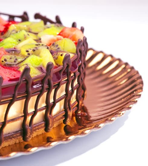 Decorating a cake with colorful frosting and sprinkles for a birthday celebration