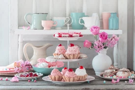 Cake decorator meticulously crafting fondant designs for custom cakes