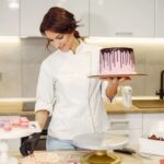 Decorating an Easter Cake Decorating an Easter cake with pastel-colored frosting, chocolate eggs, and festive bunny decorations