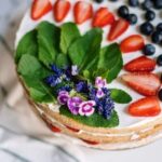 Decorate a cake with artificial flowers for a stunning, non-edible floral touch