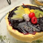 Wedding Cake Decorating WEDDING CAKE DECORATING: Elegant floral designs and intricate icing details adorn this stunning three-tiered masterpiece