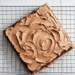 How to Decorate Mango Cake Layered mango slices with cream, topped with fresh mint leaves