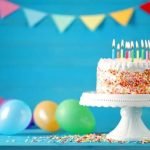 Step-by-step guide on how to decorate a Frozen cake with snowflake designs and Elsa figurine topper