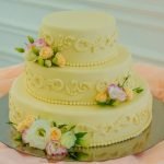 Step-by-step guide on how to decorate heart cake with icing and edible flowers