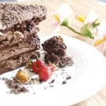 Raspberry-topped cake with decorative swirls and fresh berries, a step-by-step guide on how to decorate a cake with raspberries