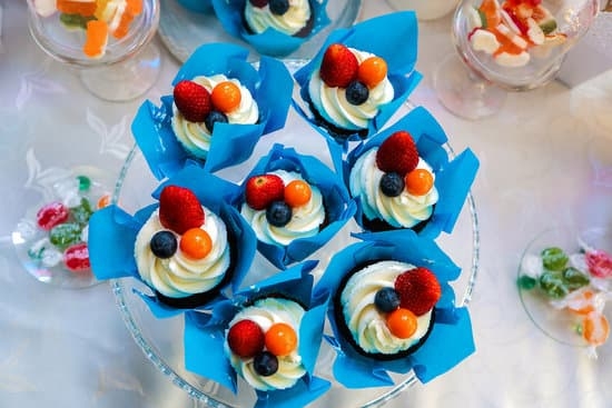 Delicious options to decorate carrot cake with include walnuts, cream cheese frosting, and edible flowers