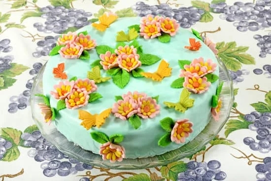 Creative chocolate cake decoration ideas using colorful sprinkles, fondant shapes, and edible flowers